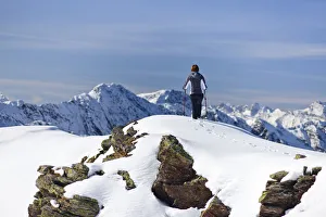 Hiker in the snow on the top of Roethenspitz Mountain above Penser Joch Pass, Sarn Valley Hiker in the snow on the top of Roethenspitz Mountain above Penser Joch Pass, Sarn Valley