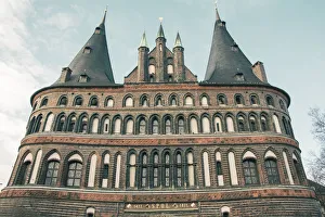 The Holsten Gate or Holstein Tor (Holstentor), a brick gothic city gate at the Hanseatic The Holsten Gate or Holstein Tor (Holstentor), a brick gothic city gate at the Hanseatic