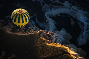 Hot air balloon over volcanic rock formation Hot air balloon over volcanic rock formation