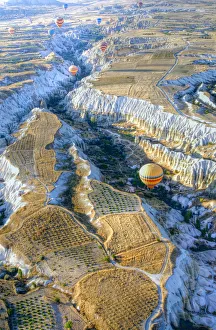 Hot air balloons above a gorgeous landscape of Cappadocia in Turkey Hot air balloons above a gorgeous landscape of Cappadocia in Turkey