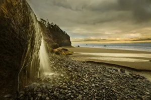Hug Point Falls flows onto beach, Hug Point State Park, Oregon, USA Hug Point Falls flows onto beach, Hug Point State Park, Oregon, USA