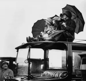 Prints of Spectators watch the races from the roof of their car during the Epsom Derby in Surrey, 27th May 1925. (Photo by Kirby/Topical Press Agency/Getty Images) Racing Prints: Epsom Derby Spectators Print, 27th May 1925