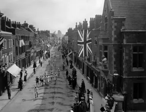 Prints of 24th July 1908: A general view of the Marathon event at the 1908 London Olympics with the competitors running along Eton High Street at Baldwins Bridge, lined with spectators and flags Sport Prints: 1908 London Olympics Marathon Print
