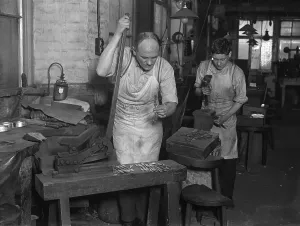 Silver Workers Print: A man inspects a fork being pressed in his tool