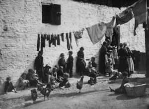 Prints of 1889: Children sitting under a washing line hanging acoss a courtyard in a slum area of London. (Photo by General Photographic Agency/Getty Images) Slums Prints: Washing Day Print 1889: Children Under a Courtyard Washing Line