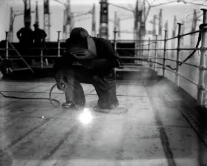 Prints of A welder at work on the construction of the liner Queen Mary at Clydebank Images Dated 2005 September: Welding Print: A welder at work on the Queen Mary liner construction