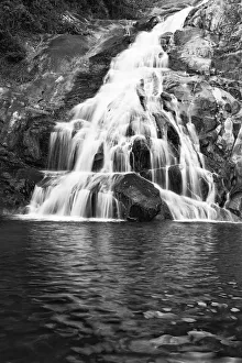 Landscape of small waterfall cascading over a rock with a long exposure - Magoebaskloof Landscape of small waterfall cascading over a rock with a long exposure - Magoebaskloof