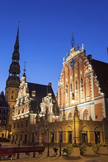 Latvia, Riga, Illuminated House of the Blackheads and St. Peters Church against blue sky Latvia, Riga, Illuminated House of the Blackheads and St. Peters Church against blue sky
