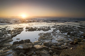 Low angle sunrise over Indian Ocean Mission rocks St Lucia, Kwazulu-Natal South Africa Low angle sunrise over Indian Ocean Mission rocks St Lucia, Kwazulu-Natal South Africa
