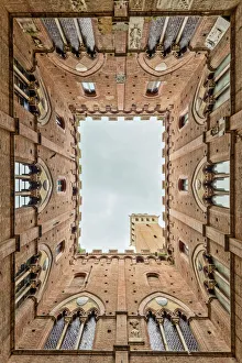 Low angle view of the Torre Del Mangia from Palazzo Pubblico Siena Tuscany Low angle view of the Torre Del Mangia from Palazzo Pubblico Siena Tuscany