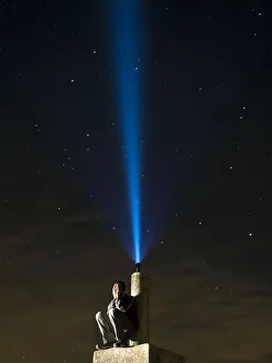 Man on top of a mountain, desperate hands on the lost face at night with a flashlight Man on top of a mountain, desperate hands on the lost face at night with a flashlight