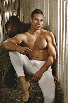 Man with a naked torso wearing long underwear in a horse