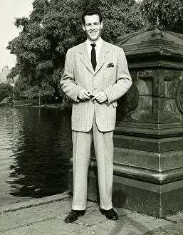 Man standing by lake in park, (B&W), (Portrait) Man standing by lake in park, (B&W), (Portrait)