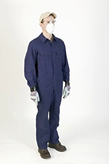 Man standing, wearing overalls, mask, gloves and cap Man standing, wearing overalls, mask, gloves and cap