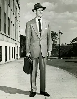 Man in full suit standing on sidewalk, (B&W), (Portrait) Man in full suit standing on sidewalk, (B&W), (Portrait)