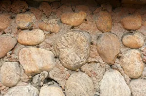 Mani stones with Tibetan inscriptions on wall, Buddhist Mani wall at Ghami, Upper Mustang Mani stones with Tibetan inscriptions on wall, Buddhist Mani wall at Ghami, Upper Mustang