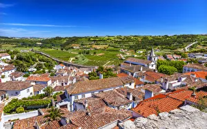 Medieval town with fortified walls and Santa Maria church, Obidos, Portugal Medieval town with fortified walls and Santa Maria church, Obidos, Portugal