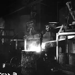 Metal Worker Pouring Metal into Moulds Print