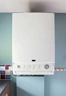 Modern boiler on blue wall in domestic kitchen Modern boiler on blue wall in domestic kitchen