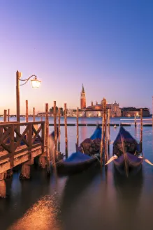 Moored gondolas in St Marks basin at sunrise. Venice, Veneto, Italy Moored gondolas in St Marks basin at sunrise. Venice, Veneto, Italy