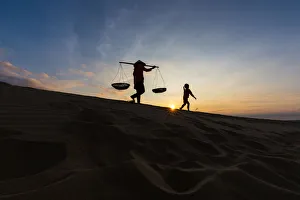 Mother and daughter on Sand Dune in beautiful sunsire / dawn Mother and daughter on Sand Dune in beautiful sunsire / dawn