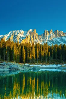 Mountain lake surrounded by pine forest (Carezza Lake in the Latemar mountain range Mountain lake surrounded by pine forest (Carezza Lake in the Latemar mountain range