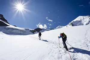 Mountaineers during the ascent of Mt Piz Palue, summit of Mt Piz Palue at back, Grisons Mountaineers during the ascent of Mt Piz Palue, summit of Mt Piz Palue at back, Grisons