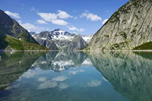 Mountains around the Grimsel Pass are reflected in Gelmerstausee reservoir, Guttannen, Canton of Bern, Switzerland Mountains around the Grimsel Pass are reflected in Gelmerstausee reservoir, Guttannen, Canton of Bern, Switzerland