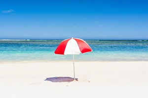 A multicolored beach umbrella on the shore. Western Australia A multicolored beach umbrella on the shore. Western Australia