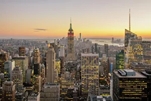 New York City skyline with illuminated skyscrapers seen from above during sunrise New York City skyline with illuminated skyscrapers seen from above during sunrise