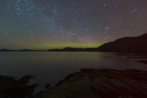 Northern Lights glowing on horizon with star trails, Settlers Cove State Park, Ketchikan Northern Lights glowing on horizon with star trails, Settlers Cove State Park, Ketchikan