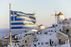 Oia village in Santorini and flag of Greece Oia village in Santorini and flag of Greece