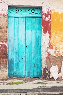 Old and beautiful turquoise door and old multicorored facade at house Old and beautiful turquoise door and old multicorored facade at house