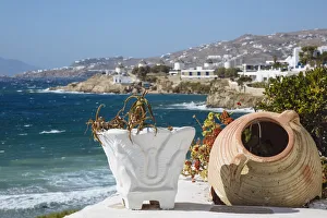 Old flower pots on foreground and Mykonos town and Aegean sea in the background, Cyclades Old flower pots on foreground and Mykonos town and Aegean sea in the background, Cyclades