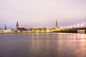 Old Riga skyline at dusk and Akmens bridge over Daugava river. Riga, Latvia Old Riga skyline at dusk and Akmens bridge over Daugava river. Riga, Latvia