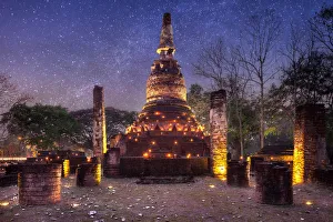 Old stupa with candlelight and milky way galaxy in the Kamphaeng Phet Historical Park Old stupa with candlelight and milky way galaxy in the Kamphaeng Phet Historical Park