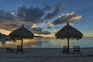 Parasols and sun loungers on the beach, evening atmosphere, Moorea, French Polynesia Parasols and sun loungers on the beach, evening atmosphere, Moorea, French Polynesia