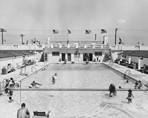 People relaxing in outdoor pool (B&W), elevated view People relaxing in outdoor pool (B&W), elevated view