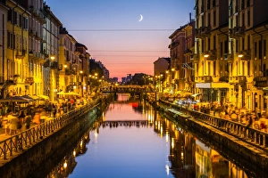 People walk on the sides of the Naviglio Grande canal in Milan People walk on the sides of the Naviglio Grande canal in Milan