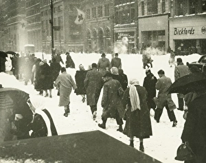 People walking on city street in blizzard, (Rear view) People walking on city street in blizzard, (Rear view)