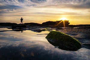 A photographer and sunset at Melasti beach, Bali A photographer and sunset at Melasti beach, Bali