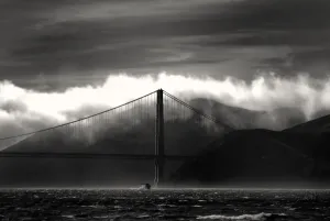 Prints of Moody, noir-like shot of the Golden Gate Bridge, the fog shrouded Marin hills, and a ferry in the distance World Famous Bridges Prints: Golden Gate Bridge Print: Foggy Marin Hills and Ferry