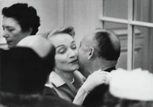Prints of German actress Marlene Dietrich (1901 - 1992) greets Christian Dior (1905 - 1957), at one of the designer's fashion shows in Paris, August 1955 Fashion Prints: Marlene Dietrich Greets Christian Dior Print, August 1955