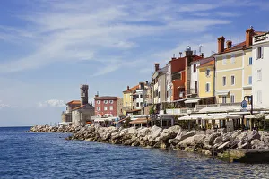 Piran lighthouse and houses at the waterfront Piran lighthouse and houses at the waterfront