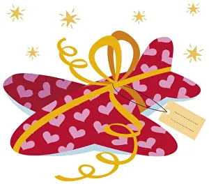Plane in red wrapping paper, tied with yellow ribbon, card attached Plane in red wrapping paper, tied with yellow ribbon, card attached
