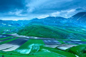 Plowed fields in the valley Monti Sibillini National Park, view from Castellucio di Norcia, Umbria, Italy Plowed fields in the valley Monti Sibillini National Park, view from Castellucio di Norcia, Umbria, Italy
