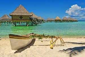 Polynesian outrigger canoe in front of pile bungalow complex, South Pacific, Bora Bora Polynesian outrigger canoe in front of pile bungalow complex, South Pacific, Bora Bora