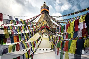 Prayer flags with the Boudhanath Stupa in Kathmandu, Nepal Prayer flags with the Boudhanath Stupa in Kathmandu, Nepal