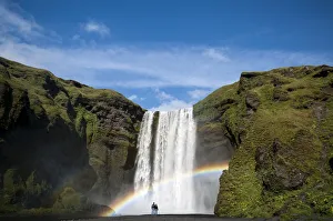 Rainbow, couple watching the Skogafoss waterfall on the Skoga river, ring road, Suourland, Sudurland, southern Iceland Rainbow, couple watching the Skogafoss waterfall on the Skoga river, ring road, Suourland, Sudurland, southern Iceland