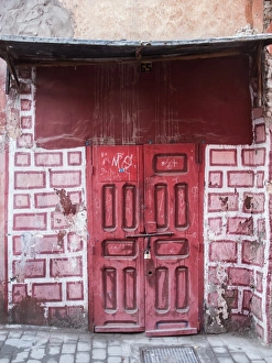 Red door in faux brick wall, Marrakech, Morocco Red door in faux brick wall, Marrakech, Morocco
